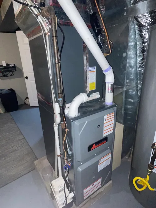 New Amana high-efficiency furnace installed in a finished basement