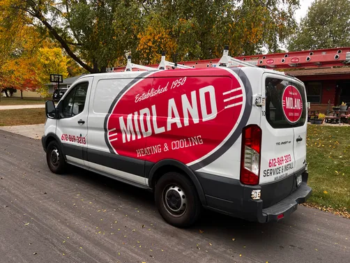 Midland Heating & Cooling branded service van parked at a job site