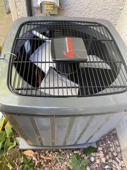 Amana air-conditioning condenser installed beside a Twin Cities home