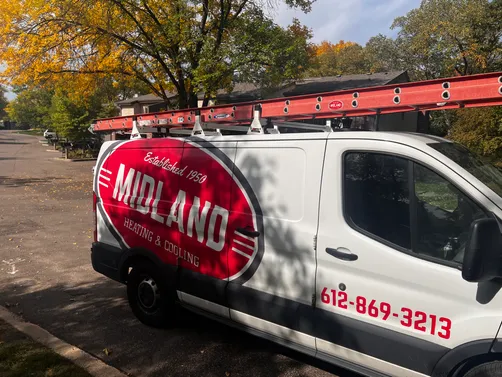 Midland Heating & Cooling van with roof ladder rack on a fall service call