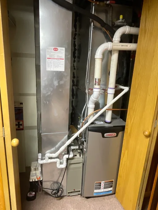 Lennox high-efficiency furnace installed in a closet with new venting