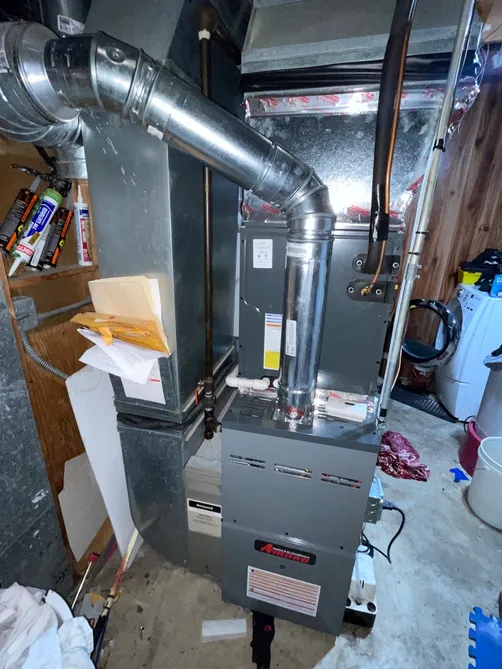 Amana furnace with metal B-vent and supply plenum in a basement