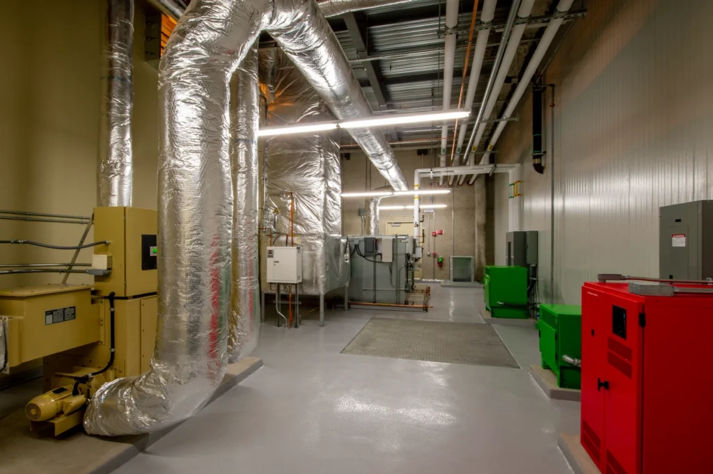 A spacious room filled with various pieces of equipment, showcasing a busy and functional environment.