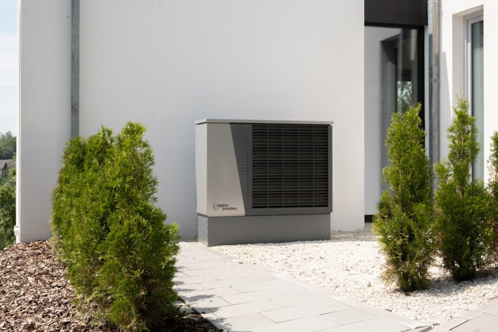 How to Integrate Ductless Systems with Your Boiler or Furnace 2 ductless mini-split indoor unit mounted on wall in older home with radiators visible