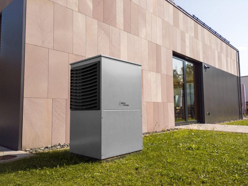heat pump technician inspecting outdoor unit in residential yard