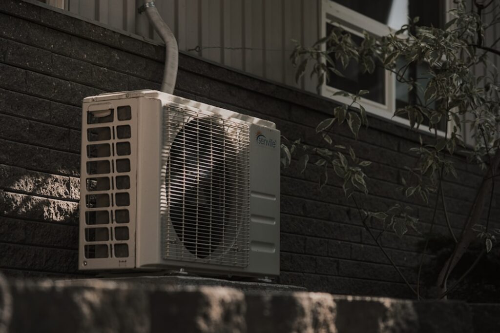 residential AC unit outside home during summer heat wave