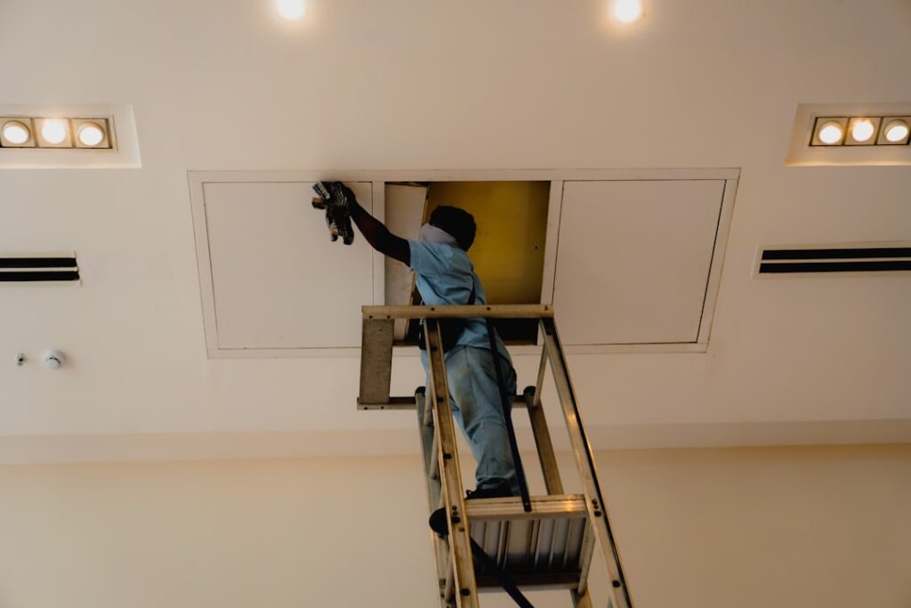 HVAC technician performing a professional AC tune-up in a Twin Cities home